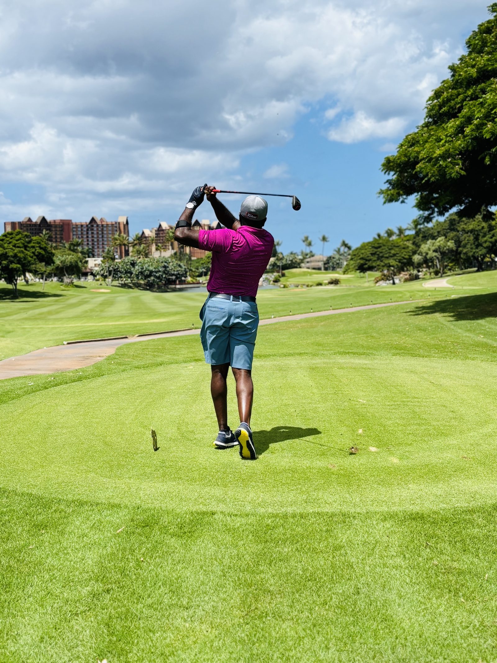 Golfer following through on a tee shot at a resort course